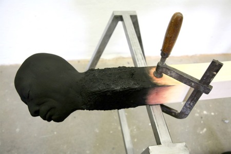 Matchstickmen: Burnt Matches Resembling Charred Human Heads by Wolfgang Stiller wood sculpture art burning faces artist