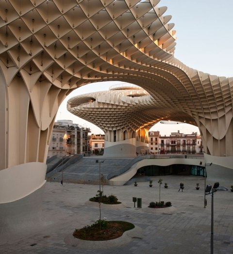 The Metropol Parasol - The world's largest wooden structure What is there not to like about Metropol Parasol?  The waffle-like crown structure in Seville, Spain has been finally completed in April 2011 after a competition held by the city of Seville in 2004.  Located at Plaza de la Encarnacion, the stunning sequence of undulating parasols comprises the world's largest wooden structure. The Metropol Parasol project was part of the redevelopment of the Plaza de la Encarnacíon, designed by J. MAYER H. Architects, this project becomes the new icon for Seville, a place of identification and to articulate Seville's role as one of the world´s most fascinating cultural destinations.